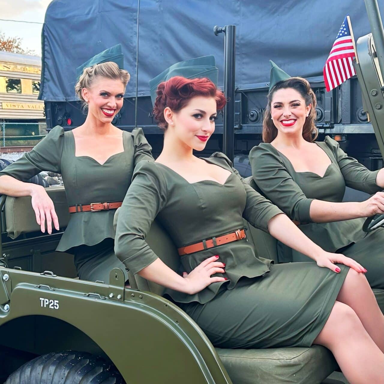 The Hollywood Dolls in a military vehicle at a public event in New Jersey