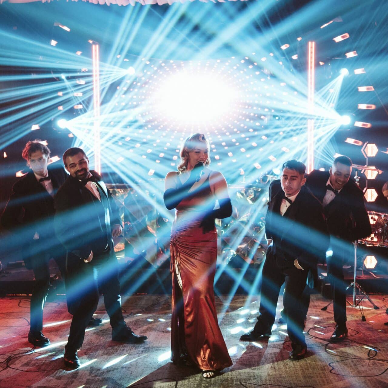 A lead singer and four dancers perform hits from Moulin Rouge