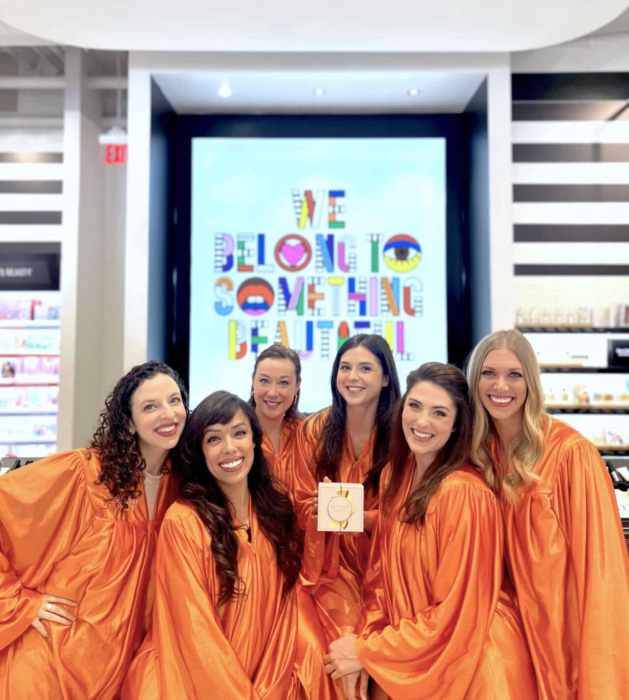 Six singers pose at a Brand Activation promoting a product with live music