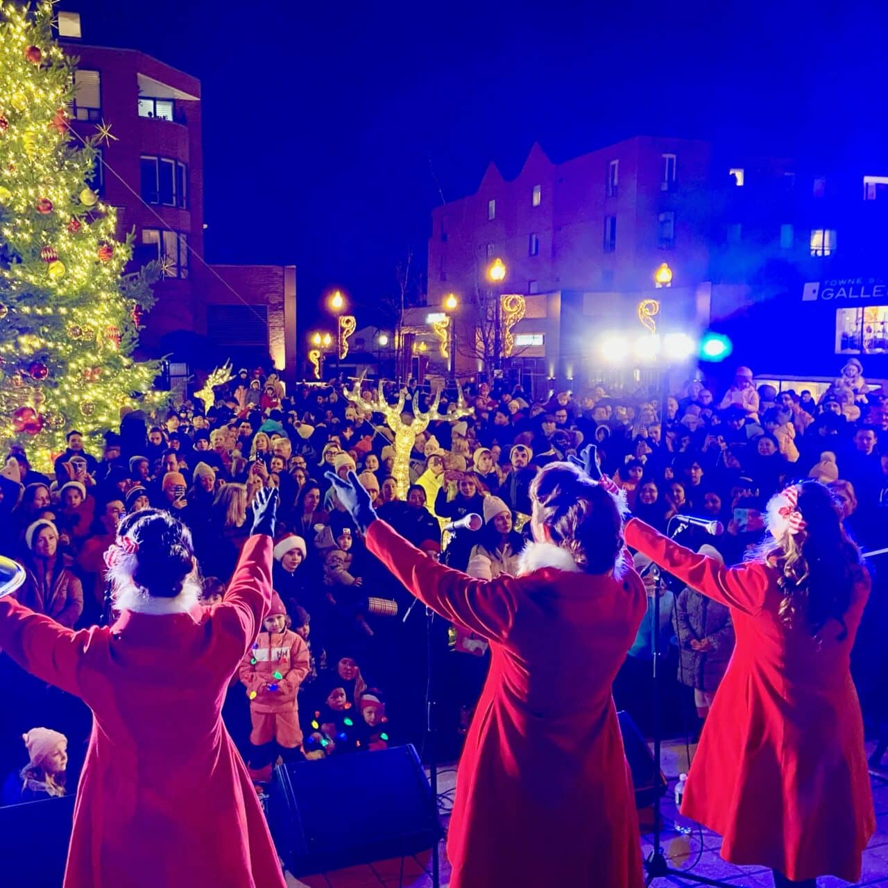 performers on stage looking into a full live audience 